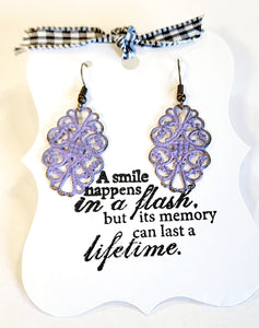 These lovely earrings will add some pizzazz to your attire!  Lightweight filigree measures 1 1/4" long by 13/16" wide, drop length of 1 7/8".  Hand-painted in a beautiful lavender color, then distressed.  Nickle and lead-free. Made in the United States