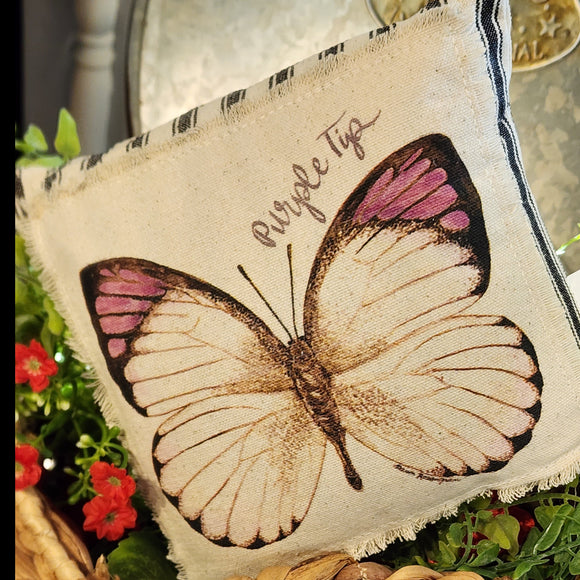 We love these sweet miniature pillows because they fit anywhere! The little Purple Tip Butterfly is printed on a muslin fabric that has been sewn onto a black-striped ticking fabric.   8