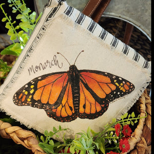 We love these sweet miniature pillows because they fit anywhere! The little Monarch butterfly is printed on a muslin fabric that has been sewn onto a black-striped ticking fabric.   8" x 8"   Cotton, Polly Fiber
