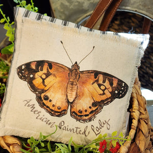 We love these sweet miniature pillows because they fit anywhere! The little American Painted Lady Butterfly is printed on a muslin fabric that has been sewn onto a black-striped ticking fabric.   8" x 8"   Cotton, Polly Fiber