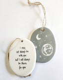 We love our porcelain ornaments because they are perfect for gift-giving! This oval ornament says, "I may not always be with you, but I will always be there for you" on one side. The other side has a grey background with stars, a crescent moon, and planet earth in the sky.  Dimensions: 2" W x 2 3/4" H