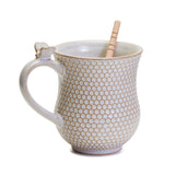 Now isn't this the sweetest thing you've seen?  Our Honeycomb raised pattern has a white glaze and on the top of the handle is a ceramic bee.  Included is a honey dipper that gathers your honey and then can stir the honey into your tea!  So adorable, you'll enjoy drinking out of it every day!  16 oz. stoneware mug dishwasher and microwave safe.  Dipper/Stirrer (schima wood) hand wash only  Mug: 5 3/4" W x 4" D x 4 3/4" H  Dipper/Stirrer: 5 3/4" L