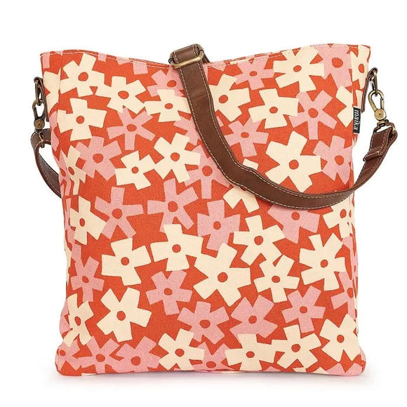 We are loving this pink and white block floral print all over a red background. It will create a statement wherever you go!  This is our most versatile, multi-tasking tote yet! Both a tote and crossbody bag, this versatile bag features a zippered top, an exterior pocket, and an expandable side pocket for your water bottle. The interior contains a padded tablet divider, three interior pockets (1 zippered), one pen insert, and a strap and hook to attach our pouches.