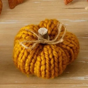 We love these cozy sweater pumpkins!  This one is a rich gold color and has a wooden stem with a twine bow tied around it.  Perfect for adding some texture and color to your fall decor!  3" H x 3.5" Dia  Fabric, Polyfoam