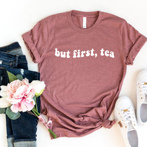 We know you're a tea lover, but does anyone else?  If you drink tea as we do, you will love wearing this "But First, Tea" t-shirt!  The white lettering is on a rose-colored t-shirt. Pair it with your favorite jeans and flats!  SIZING Unisex. The fit is more relaxed than typical women’s shirts fit.  CARE - Turn the garment inside out and wash cold on a delicate cycle. - Lay flat to dry. - Do not bleach, dry clean, or iron directly onto the design. Made in Canada