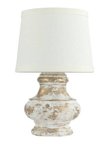 white shaded lamp with a white and silver distressed base