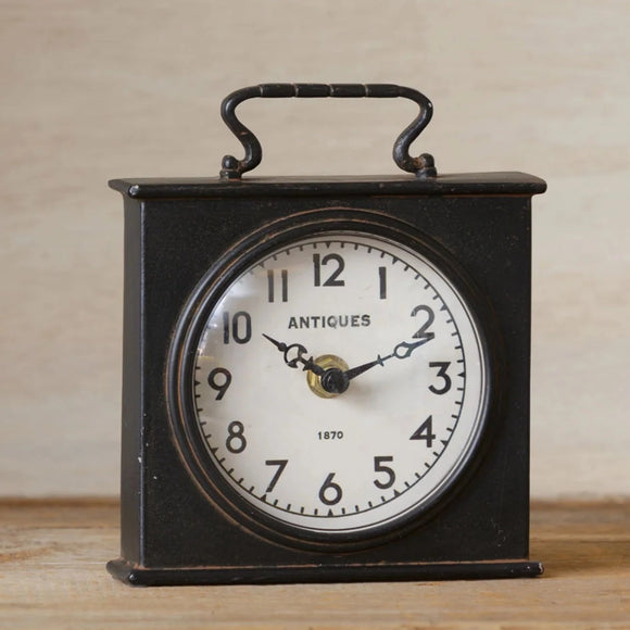 One of our favorites! This square, black clock has a white round face with the words 