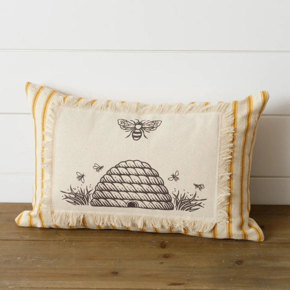 Oh, honey, you'll be the Queen Bee with this rectangle pillow!  The background of the pillow is a fresh & fun yellow stripe on a cream background. On top of that is a cream rectangle with frayed edges sewn all around the edges. Inside the frayed rectangle is a black drawing of a beehive with a bee above it.    10