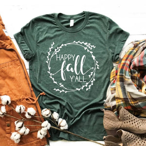 Such a darling t-shirt to wear to welcome in fall!  This pretty heathered forest t-shirt has the words "Happy Fall Y'All" inside a circular wreath in white. These are so soft & comfy; you will love wearing them to ball games, bonfires, or just running around doing errands. The styling possibilities are endless. Roll up the sleeves, tie a side knot, front tuck, or wear it while lounging around the house. We guarantee that you will love this shirt's fit and softness.