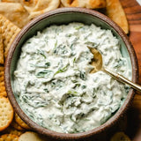Our new and improved creamy spinach dip is perfect with veggies, in a bread bowl, or as a spread on pita bread or crackers. This fan favorite is a must at any gathering! Mix in 1 Cup sour cream, 1 Cup mayonnaise, and (1) 10 oz. Package of frozen, chopped spinach, thawed and drained. Refrigerate until ready to serve. 