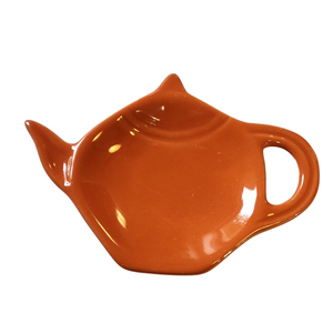 Get one of our cute retro-inspired teapot-shaped tea bag holders to help keep the drips from your teabags from going anywhere!  Copacabana Orange, single glaze lead-free ceramic ware.  Approximately 5" w x 3.25" h