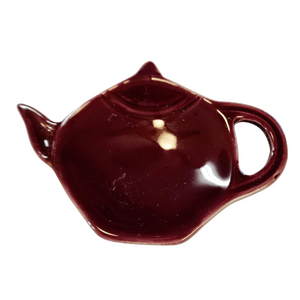 Get one of our cute retro-inspired teapot-shaped tea bag holders to help keep the drips from your teabags from going anywhere!  Plum, single glaze lead-free ceramic ware.  Approximately 5" w x 3.25" h