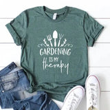 Our "Gardening Is My Therapy" t-shirt is the prettiest shade of green with white writing below cute gardening tools! These are so soft & comfy that you will love wearing them everywhere. The styling possibilities are endless. Roll up the sleeves, tie a side knot, front tuck, or wear it while lounging around the house. 