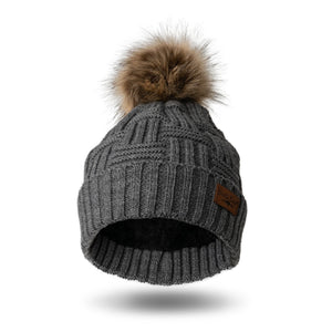 Stay warm and fashionable with our Britt Knits grey cable knit hat with a tan and brown faux fur pom. The inside is ultra-cushy and velvety, so you'll never want to take it off!! It can be worn fitted or slouched with a subtle braided design to match any style coat, jacket, or tee.