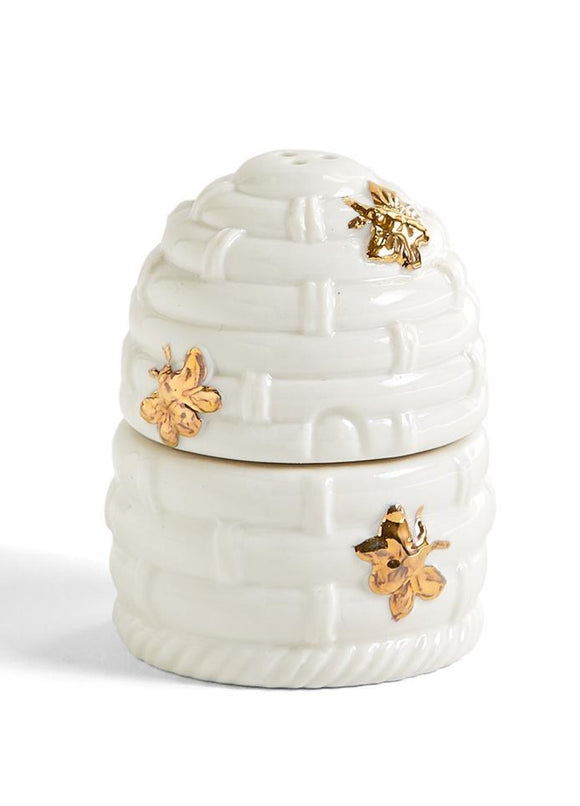A white porcelain bee hive with three gold bees.  The hive is split in half and the bottom half is for salt (it has one gold bee on it and has one hole in the top for salt) The top half of the hive has two bees on it and has three holes in the top and is for the pepper to go in)