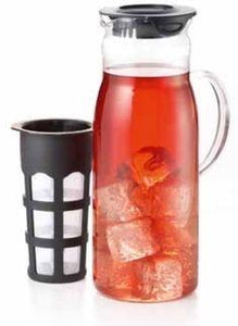 A glass pitcher with handle and a black plastic lid sits beside a plastic strainer with nylon mesh to brew your ice tea in.