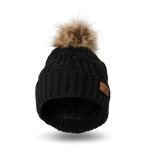 Stay warm and fashionable with our Britt Knits black cable knit hat with a tan and brown faux fur pom. The inside is ultra-cushy and velvety, so you'll never want to take it off!! It can be worn fitted or slouched with a subtle braided design to match any style coat, jacket, or tee.
