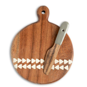 Set the table in style with this mini wood serving board that has a beautiful triangle design along the bottom. Included is a wooden spreader with a pebble-colored handle. It is fun to serve your favorite cheeses or munchies or as a fun gift idea for a new homeowner.  5"w x 6.5"h  Acacia wood, Handwash Only, Food Safe