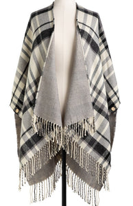 Whether snuggling up or going out, our soft acrylic Reversible Plaid Kimono is a closet must-have. We love that it gives us two looks in one, but we also love the side buttons that make armholes and keep your kimono around your shoulders! Unbutton them to use as a big blanket scarf! So many possibilities!  50 w x 30" long with 4" fringe  Do Not Iron, Do Not Bleach, Lay Flat to Dry, Do Not Tumble Dry, Machine Wash - Cold