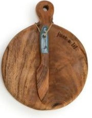 Set the table in style with this mini wood serving board that says "just a lil'" at the top. Included is a wooden spreader with a turquoise handle. It is so fun to serve your favorite cheeses or munchies on, or as a fun gift idea for a new homeowner.  5"w x 6.5"h  Acacia wood, Handwash Only, Food Safe